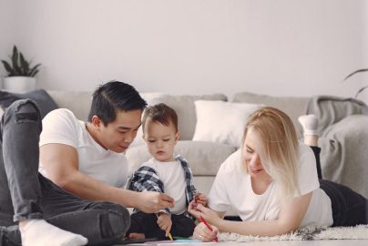 A joyful family drawing together indoors, fostering love and creativity.