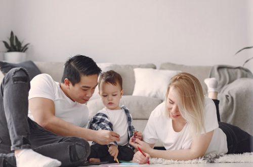 A joyful family drawing together indoors, fostering love and creativity.